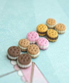 there are some cookies on the table with pink and brown icing around them,