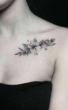 a woman with a flower tattoo on her chest