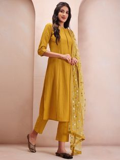 Mustard yellow & silver solid Kurta with Trousers & dupattaKurta design:SolidStraight shapeRegular styleRound neckThree-quarter regular sleevesSequinned detailCalf length with flared hemSilk blend machine weave fabricTrousers design:Solid TrousersPartially elasticated waistbandSlip-on closure Yellow Dabka Embellished Dupatta For Party, Yellow Dabka Dupatta For Party, Yellow Dabka Party Dupatta, Semi-stitched Yellow Kurta With Self Design, Fitted Yellow Kurta With Sheer Dupatta, Yellow Dabka Kurta For Party, Yellow Kurta For Eid Party, Yellow Self Design Churidar For Diwali, Yellow Self-design Churidar For Diwali