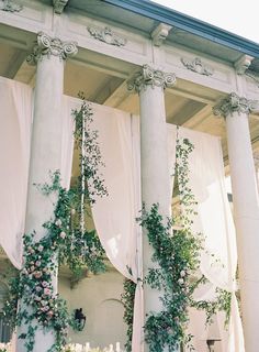 the columns are covered with flowers and greenery