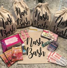 three bags filled with personal care items sitting on top of a marble counter next to each other