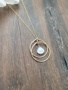 Beautiful Crescent Moonstone Circle Necklace. The Two circles create a Crescent moon shape at the bottom of the circles. Moonstone is said to be linked to to the divine feminine. It is believed to connect with the moon's energy, bringing balance, calm, abundance, and intuition to the person wearing it. The circles are hand formed and hammered for texture and shape. The pendant hangs down a little longer than 1 1/4 in. The length worn in the picture is at 18 in. Each piece is handmade and may var Moonstone Jewelry With Moon Charm For Meditation, Meditation Moonstone Jewelry With Moon Phase Detail, Moonstone Necklace With Moon Charm For Meditation, The Divine Feminine, Moon Shape, Moon Shapes, Circle Necklace, The Divine, Divine Feminine