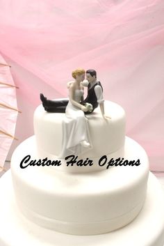 a wedding cake with a bride and groom on top