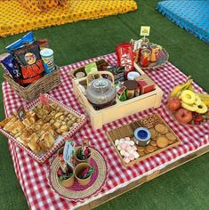 a picnic table with food and snacks on it