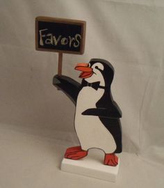 a penguin holding a sign that says favors