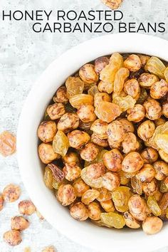 a bowl filled with roasted garbanzo beans on top of a white countertop