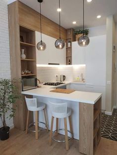 a kitchen with white counter tops and stools