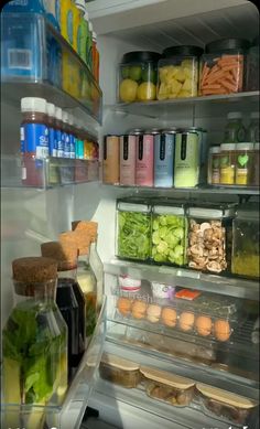 an open refrigerator filled with lots of food and condiments on the shelves next to each other