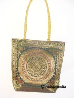 "Indian Handmade Banarasi Brocade shoulder Bag. Made with soft Banarasi Brocade. It has zip closure on the top so it is safe to carry around your mobile,tablet and other belongings and also a small zip closure compartment so you can put your money in it. Available in multiple colors which can be matched with your outfit. Check our shop for more colors and varieties. Bag size- 12\" x 12\" Color - Dark Green --------------------------------------------------------------------- Postage & Shipping - Gold Tote Shoulder Bag As A Gift, Gold Handheld Shoulder Bag Gift, Traditional Gold Shoulder Bag For Festivals, Handmade Multicolor Shoulder Bag For Weddings, Bohemian Gold Bags For Festivals, Gold Bohemian Bags For Festivals, Bohemian Gold Bags For Festive Occasions, Gold Tote Gift Bag, Bohemian Gold Rectangular Potli Bag