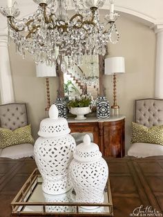 a chandelier hanging from the ceiling in a living room