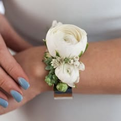 a close up of a person's arm wearing a bracelet with flowers on it