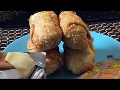 a blue plate topped with two fried food items next to a bag of rice krispy kreme