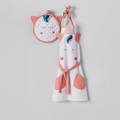 a baby's towel and bib hanging on a wall