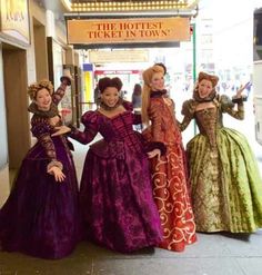 four women dressed in period costumes posing for a photo outside the theater theatre, there is a sign that says'the hotten tweet in lon '