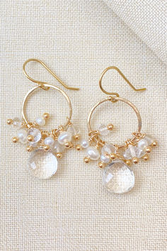 The foundation of these earrings is gold-filled circles, which I lightly hammered for a subtle texture. Beautifully faceted, crystal quartz briolettes are suspended from the circles to anchor the design. These perfectly clear stones are then crowned with clusters of tiny freshwater pearls and more petite faceted crystal quartz beads. Enjoy wearing these brilliant stones in radiant gold fill with everything from jeans and sweaters to your favorite little black dress. Cluster Earrings Tutorial, Pearl Cluster Earrings, Ear Art, Ear Accessories, Diy Jewelry Unique, Pearl Cluster, Earring Tutorial, Quartz Beads, Ear Rings