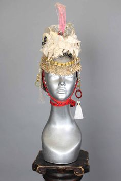 This is a one of a kind piece of wearable art made for the Five and Diamond Seventh Annual Headgear Art Show and shown on August 2, 2019. There is a lot of symbolism around white butterflies. If the first butterfly you see in the year is white you will have good luck all year. White butterflies are symbols of spiritual change. In the Philippines, seeing a white butterfly means that there is a message coming. In Ireland, they were thought to carry the souls of dead children. To the Blackfoot, the Unique Festival Headpiece With Tall Crown, Unique Handmade Ceremonial Headpieces, Unique Tall Crown Headpiece For Festival, Unique Headpieces For Carnival Festival, White Tall Crown Headpieces For Festivals, White Bohemian Ceremonial Headpiece, Handmade Unique Headpiece For Festivals, Ceremonial White Handmade Headpieces, Ceremonial Handmade White Headpiece