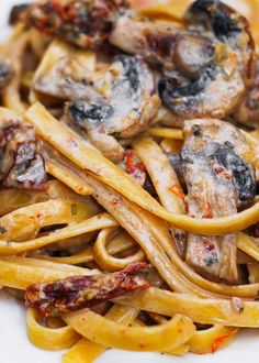 pasta with mushrooms and sauce on a white plate