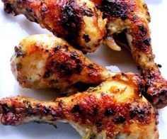 three pieces of chicken sitting on top of a white plate