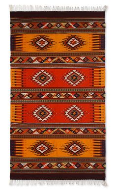 an orange and brown rug with fringes on top of the rug is shown in front of a white background