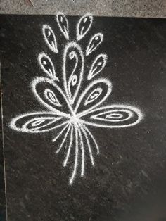 a black board with white chalk on it and a flower drawn in the bottom half