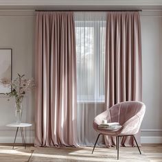 a living room with pink curtains and a chair