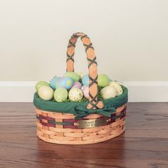 a basket filled with eggs on top of a wooden table