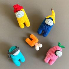 four crocheted toys are arranged on a table