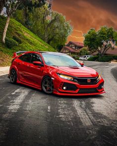 a red car parked on the side of a road