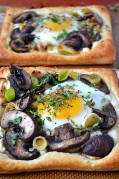 two square pizzas topped with mushrooms and an egg