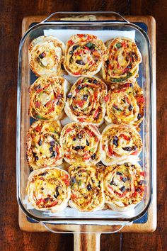 a tray filled with lots of different types of food on top of a wooden table