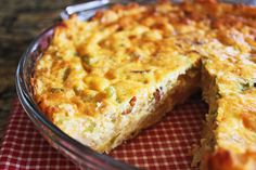 a cheesy casserole with one slice cut out