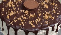 a cake with chocolate icing and crumbs on top