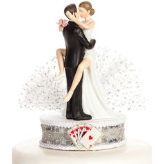 a bride and groom figurine on top of a cake