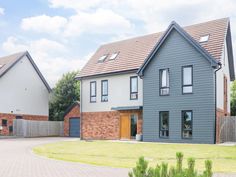 two story houses with brick and shingles on the front, side and back sides