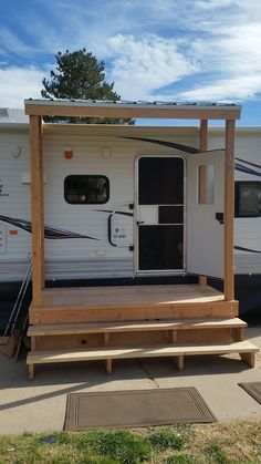 an rv is parked on the side of the road with steps leading up to it