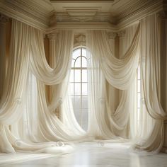 an empty room with white drapes hanging from the ceiling