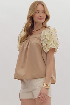 Light mocha top with large cream layered ruffle puff sleeves Unleash your inner fashionista with our Perfectly Puffed Light Mocha Top! Her square neckline and layered ruffle puff sleeves add a touch of elegance to any outfit. Elevate your style effortlessly and make a statement - whether casual or dressy, you'll trend wherever you go! True to size fit; relaxed silhouette Model is 5'10" wearing a small Fabric does contain stretch Square neckline front and back Large ruffle puffed short sleeves wi Summer Puff Sleeve Top With Ruffles And Square Neck, Square Neck Puff Sleeve Top With Ruffles For Brunch, Trendy Puff Sleeve Top With Ruffles And Square Neck, Trendy Puff Sleeve Top With Ruffles For Spring, Trendy Spring Puff Sleeve Top With Ruffles, Chic Tops With Ruffle Balloon Sleeves, Chic Balloon Sleeve Top With Ruffles, Summer Ruffled Puff Sleeve Top For Brunch, Summer Puff Sleeve Top With Ruffles For Brunch