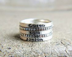 "Skinny sterling silver rings are just the right width to hold a name, a word, or a thought as a reminder on your finger. Because they are so narrow you can easily stack them with other words or names or with any decorative rings. This listing is for ONE 2mm stamped ring. I have both upper and lowercase letters and numbers in this simple font. Make sure you include your text in the box at check out exactly as you would like it to appear on the ring. These are all hand stamped which adds to their