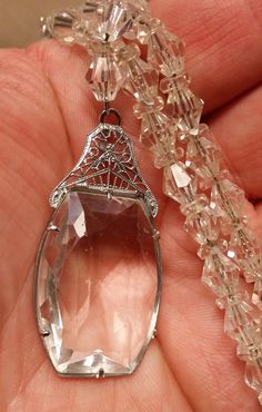 "Edwardian Faceted Crystal Filigree Rhodium Necklace strung on chain. Pendant has filigree rhodium and a large odd shaped faceted prong set crystal. The pendant measures 1-1/2\" x 7/8\". There are a few flea bites and scratches that can be seen using a loupe. The stunning pendant is connected to bi-cone crystals and crystal spacers that are strung on chain. Measures 16\". This is in very good condition. A gorgeous piece of jewelry!" Scarab Bracelet, Weird Shapes, Chatelaine, Choker Necklaces, Faceted Crystal, Chain Pendant, Etsy Items, Spring Rings, Antique Jewelry