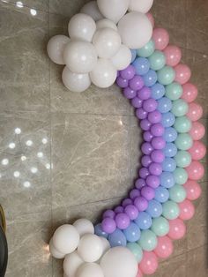 balloons are arranged in the shape of a rainbow