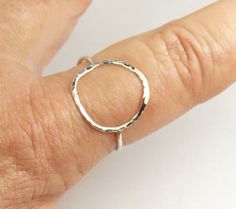 A hammered circle ring made with 18 gauge wire. Modern and simple minimal jewelry. Made with sterling silver Handmade and polished to a high shine in my shop. The circle symbol meaning is universal, sacred and divine. It represents the infinite nature of energy, and the inclusivity of the universe. Purity ring, karma ring, midi ring modern and simple Moisture in the air or on the skin can react with the %7 copper present in all Sterling Silver jewelry, causing a green discoloration. size 4-13 1/ Minimalist Hammered Sterling Silver Midi Rings, Hammered Sterling Silver Midi Rings, Hand Forged Sterling Silver Stackable Rings, Silver Hammered Midi Rings, Karma Ring, Circle Symbol, Purity Ring, Midi Ring, Circle Ring