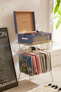 a record player sitting on top of a metal stand