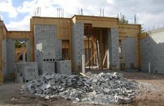 a pile of cement sitting in front of a building under construction