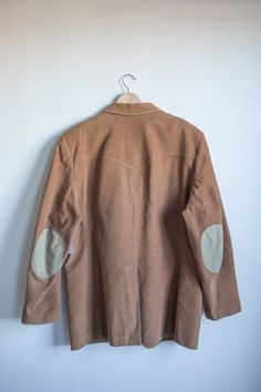 Beautiful heavy weight tan corduroy western jacket with perfect elbow patches. Fits like an xl or xxl and is in excellent condition. Please reach out via connect@shophedda.com for more photos or information. Found items are final sale. Fall Corduroy Sport Coat With Long Sleeves, Fall Long Sleeve Corduroy Sport Coat, Brown Corduroy Long Sleeve Blazer, Brown Corduroy Blazer With Long Sleeves, Vintage Corduroy Outerwear With Patch Pockets, Brown Corduroy Sport Coat For Fall, Brown Corduroy Sport Coat For Winter, Winter Brown Corduroy Sport Coat, Brown Corduroy Single-breasted Sport Coat