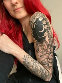 a woman with red hair has a tattoo on her arm and is looking at the camera