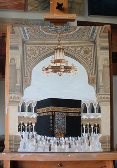 an image of the ka'bah in front of a painting on easel