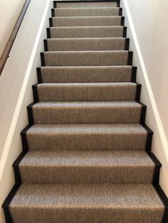 a carpeted staircase leading up to the second floor