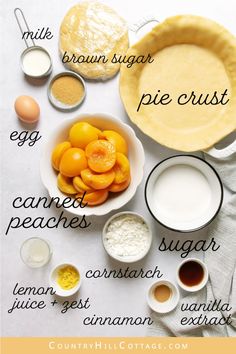 ingredients for pie sitting on top of a white table with oranges, eggs and flour