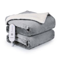 two blankets are stacked on top of each other with an electric heated blanket plugged in