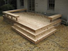 a wooden deck in front of a house